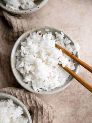 Learn how to make steamed rice that's perfectly cooked, fluffy and delicious in 30 minutes. Cook white rice on the stove, rice cooker, or instant pot. | aheadofthyme.com