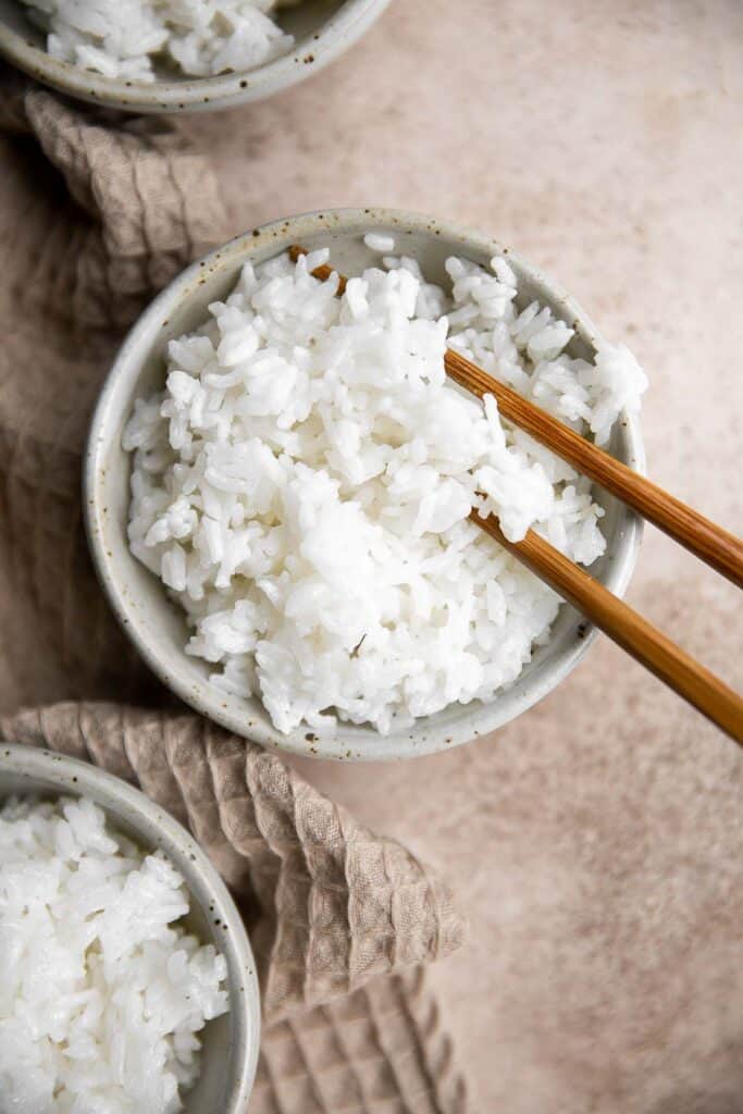 Learn how to make steamed rice that's perfectly cooked, fluffy and delicious in 30 minutes. Cook white rice on the stove, rice cooker, or instant pot. | aheadofthyme.com