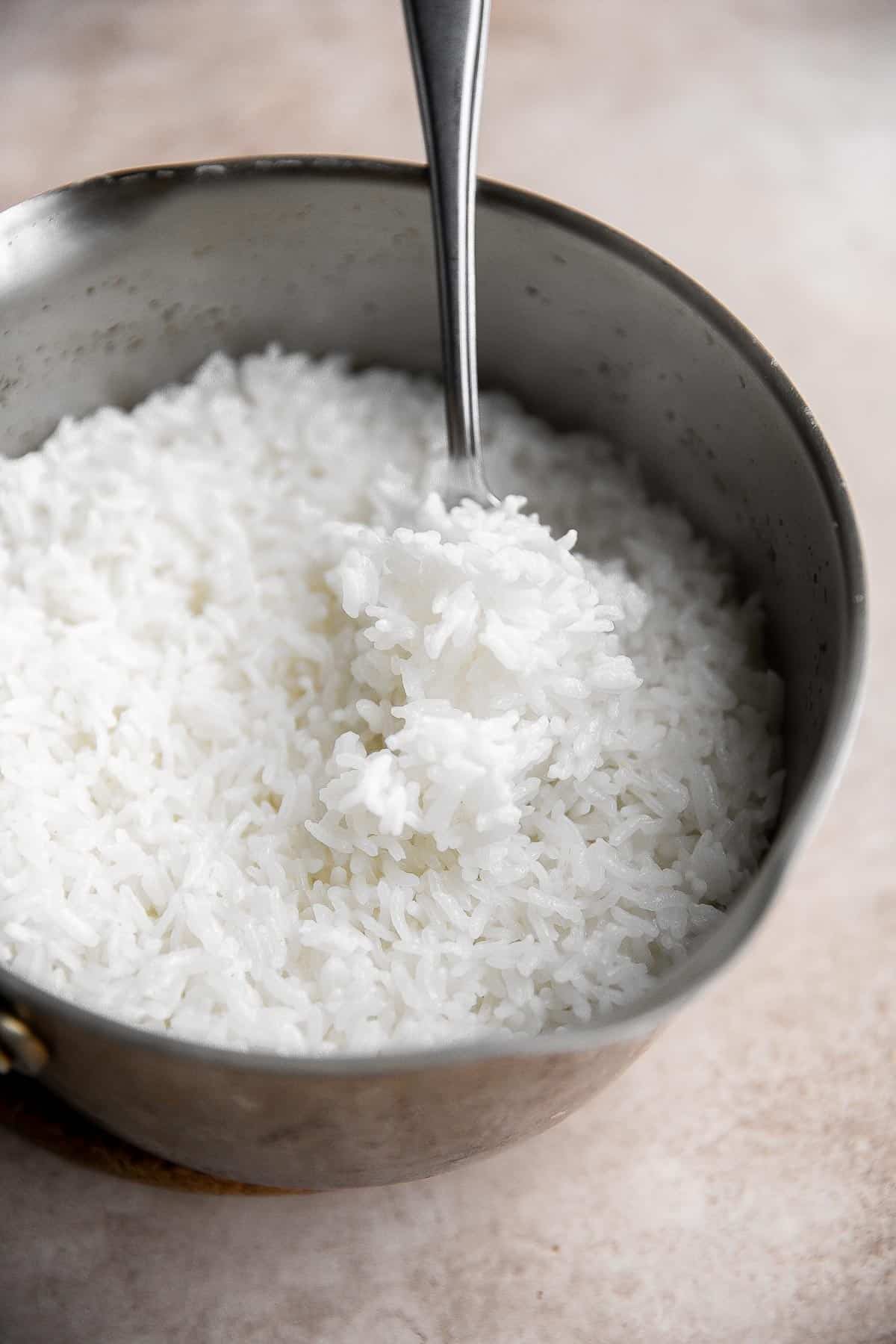 Learn how to make steamed rice that's perfectly cooked, fluffy and delicious in 30 minutes. Cook white rice on the stove, rice cooker, or instant pot. | aheadofthyme.com