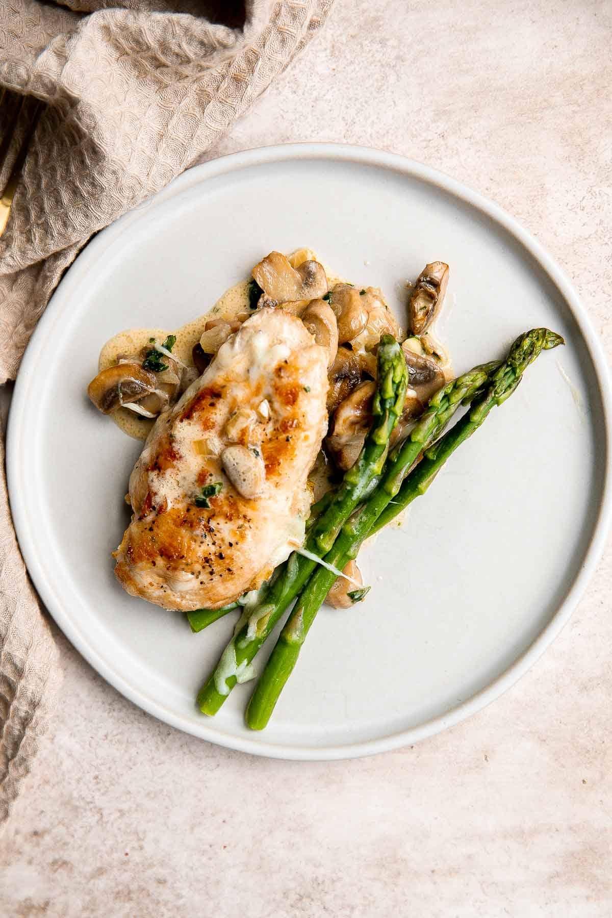 Chicken Madeira Cheesecake Factory copycat with mushrooms, crisp tender asparagus, and creamy Madeira sauce. Easy restaurant quality dinner at home. | aheadofthyme.com