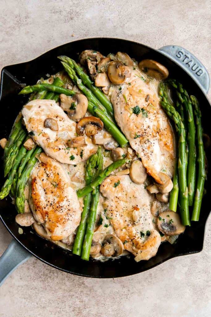 Chicken Madeira Cheesecake Factory copycat with mushrooms, crisp tender asparagus, and creamy Madeira sauce. Easy restaurant quality dinner at home. | aheadofthyme.com