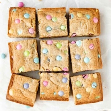 Easter blondies are rich, sweet, and moist, loaded with festive M&M's which makes them fun to make and eat. Plus, it's a quick and easy one bowl recipe. | aheadofthyme.com