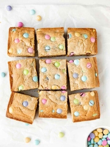 Easter blondies are rich, sweet, and moist, loaded with festive M&M's which makes them fun to make and eat. Plus, it's a quick and easy one bowl recipe. | aheadofthyme.com