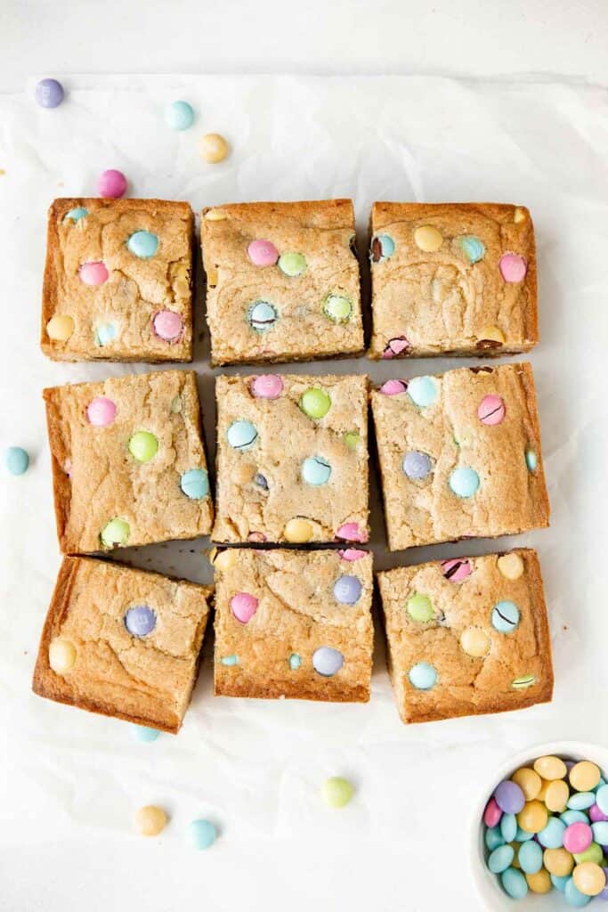 Easter blondies are rich, sweet, and moist, loaded with festive M&M's which makes them fun to make and eat. Plus, it's a quick and easy one bowl recipe. | aheadofthyme.com