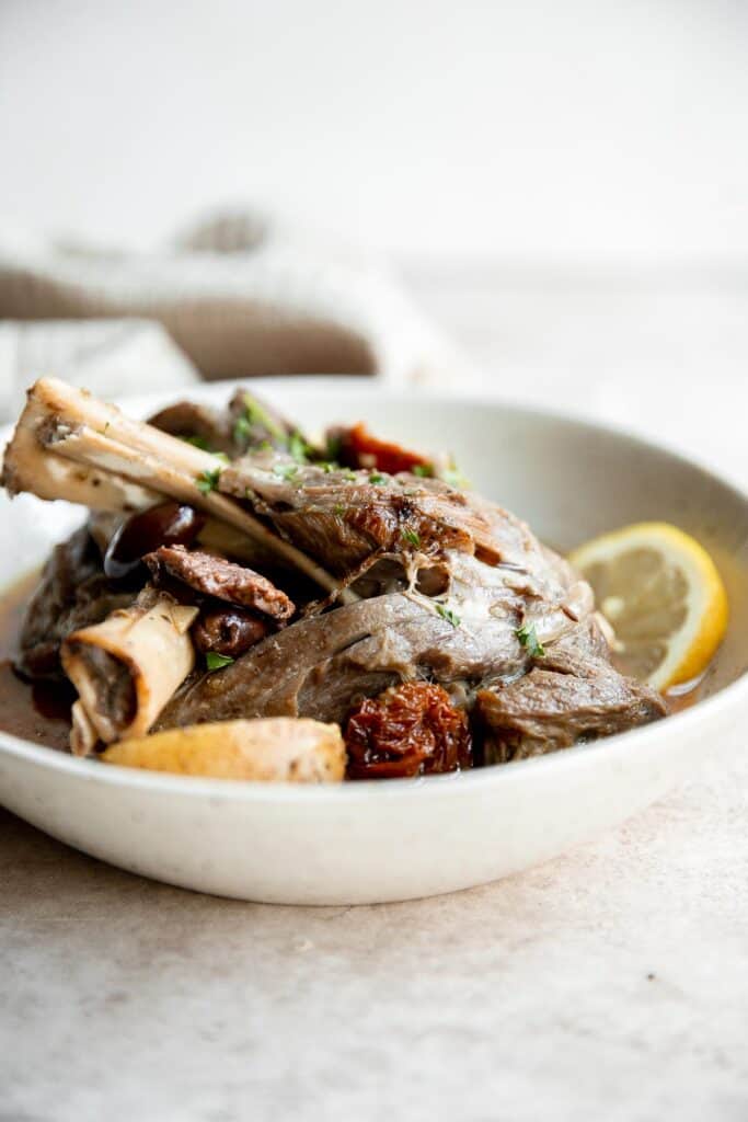 Greek lamb shanks are tender, flavorful, delicious, and literally fall off the bone. Make this Mediterranean lamb in the oven, instant pot, or slow cooker. | aheadofthyme.com