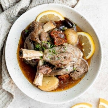 Greek lamb shanks are tender, flavorful, delicious, and literally fall off the bone. Make this Mediterranean lamb in the oven, instant pot, or slow cooker. | aheadofthyme.com