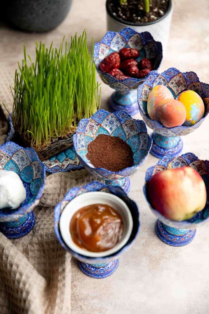 A complete guide to the traditional haft-sin table for Norouz (Persian New Year) including 7 essential items, common additional items, and Persian desserts. | aheadofthyme.com