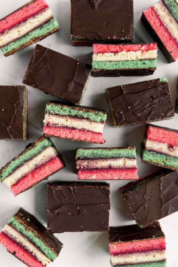 Italian rainbow cookies are delicious, colorful, fluffy, and gorgeous, made with three cake layers sandwiched in between jam and covered in chocolate. | aheadofthyme.com