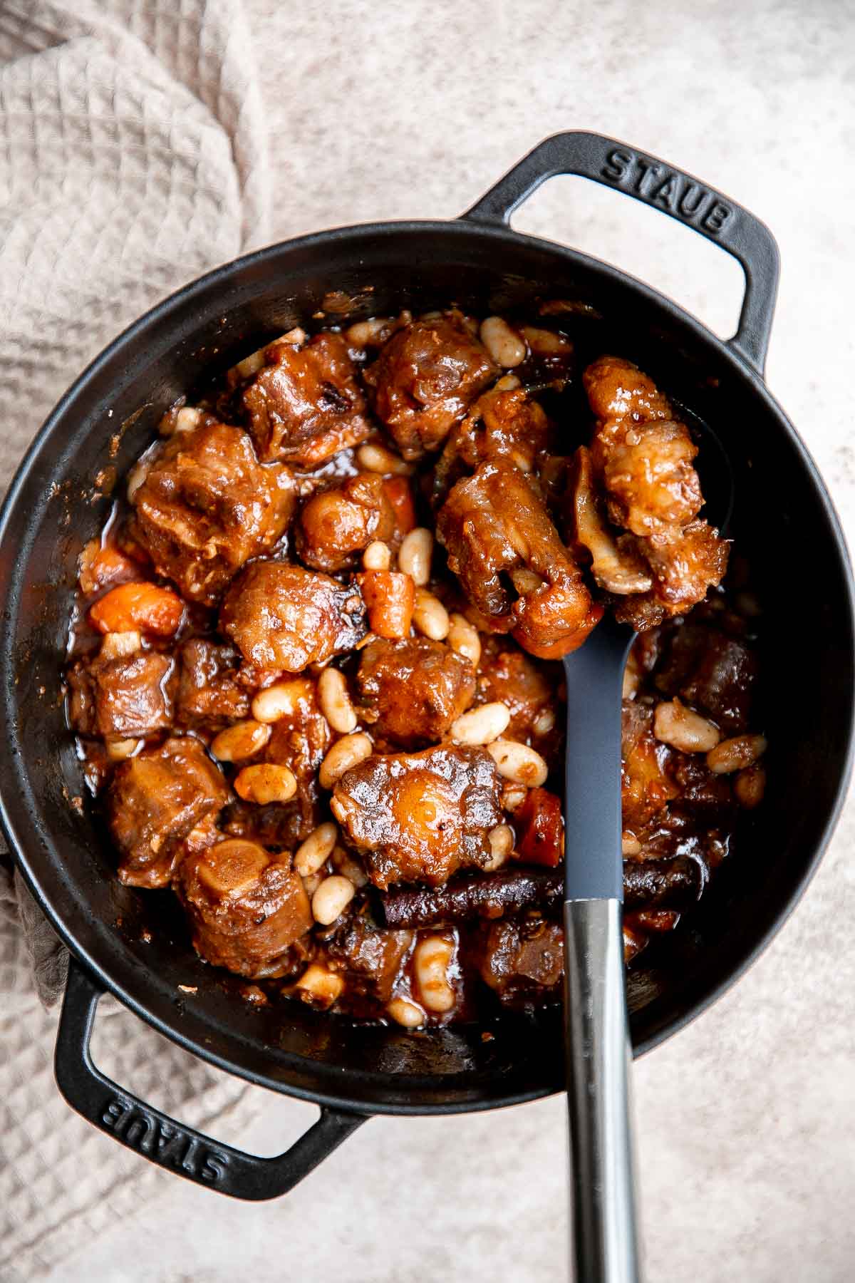 Jamaican Oxtail is juicy, delicious, and flavorful dish made with tender oxtails that fall off the bone and slow braised in a rich sauce with butter beans. | aheadofthyme.com