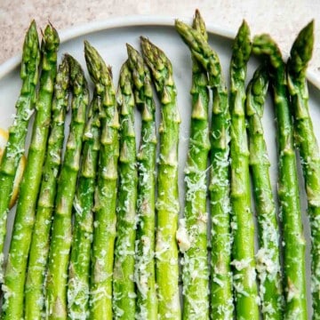 Lemon parmesan asparagus is a delicious way to serve a classic spring vegetable. This side dish is quick and easy to make in less than 20 minutes. | aheadofthyme.com