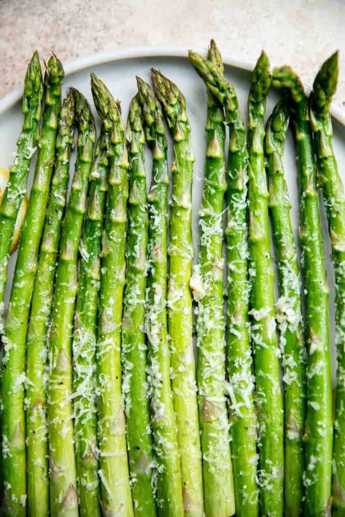 Lemon parmesan asparagus is a delicious way to serve a classic spring vegetable. This side dish is quick and easy to make in less than 20 minutes. | aheadofthyme.com