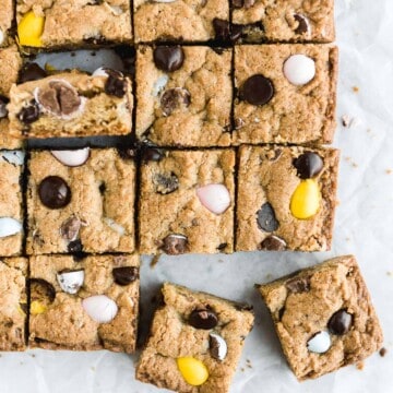 Mini egg cookie bars are a quick easy one bowl Easter dessert — soft and chewy with perfect crisp edges and a gooey center and loaded with mini eggs. | aheadofthyme.com