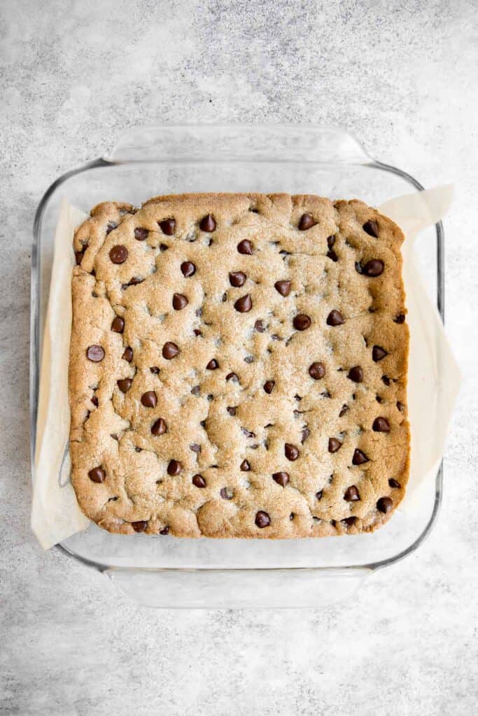 Soft and chewy chocolate chip cookie bars are a quick, easy, and lazy version of classic chocolate chip cookies that take half the prep time. | aheadofthyme.com