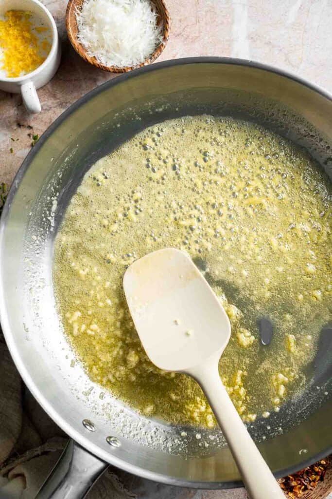 Garlic cooking in butter for lemon butter pasta sauce.