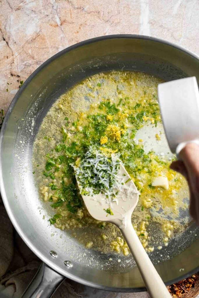 Adding fresh lemon zest to the lemon butter pasta sauce.