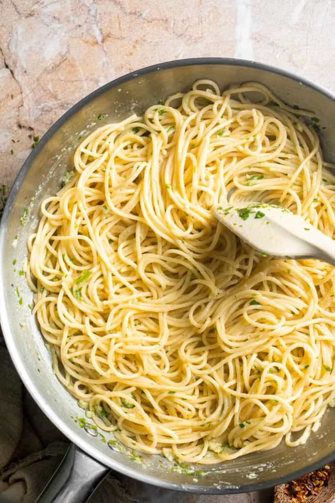 Tossing spaghetti in the lemon butter sauce.