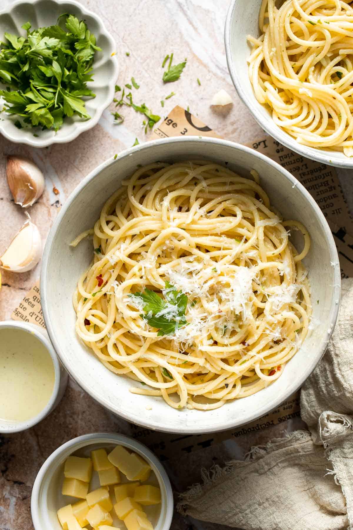 Lemon butter pasta served in a bowl with Parmesan cheese.