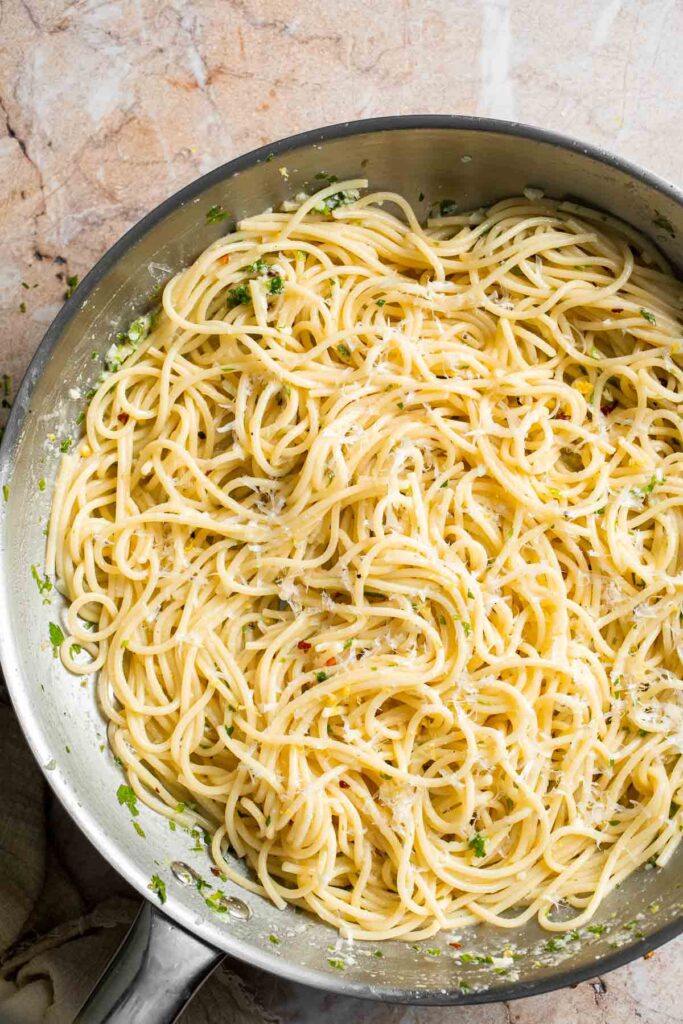 Finished lemon butter pasta with garlic, Parmesan cheese, parsley, and fresh lemon.