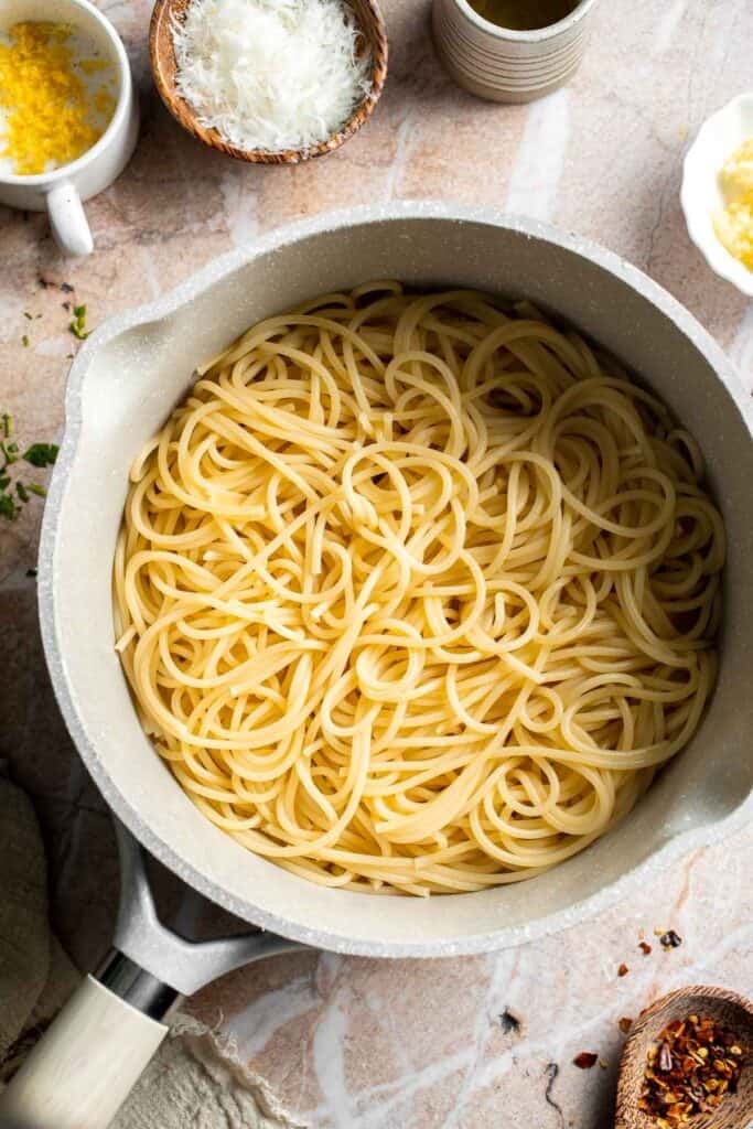 Cooked spaghetti drained and ready for lemon butter pasta.