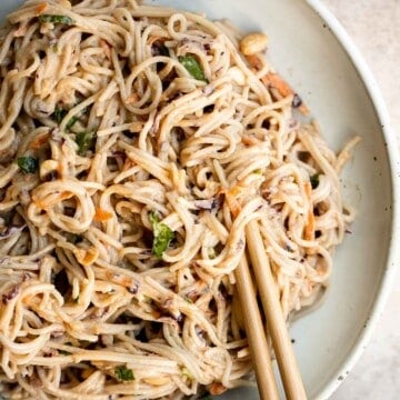 Peanut noodles are creamy, nutty, and delicious. This quick and easy, vegan homemade takeout recipe is loaded with flavor and is ready in 15 minutes. | aheadofthyme.com