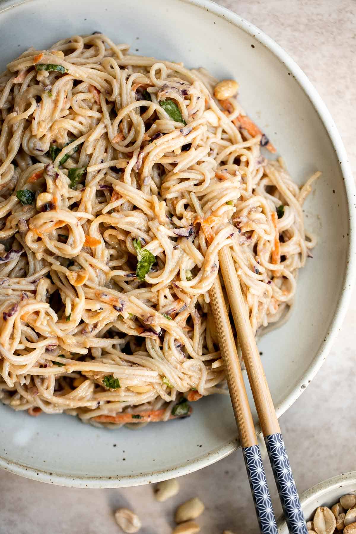 Peanut noodles are creamy, nutty, and delicious. This quick and easy, vegan homemade takeout recipe is loaded with flavor and is ready in 15 minutes. | aheadofthyme.com