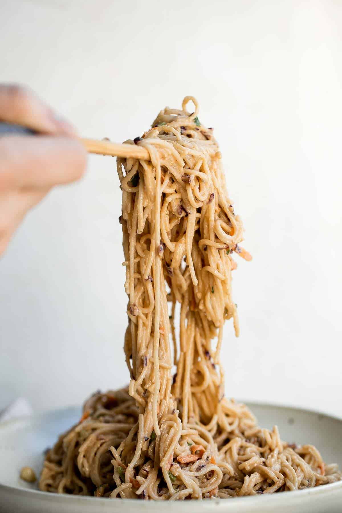 Peanut noodles are creamy, nutty, and delicious. This quick and easy, vegan homemade takeout recipe is loaded with flavor and is ready in 15 minutes. | aheadofthyme.com