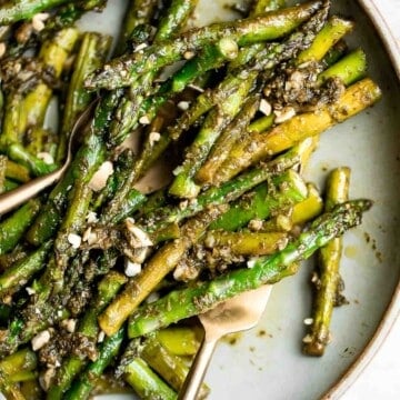 Pesto asparagus is a quick easy side dish that takes regular sautéed asparagus to the next level in just 15 minutes. It's healthy, vegan, and gluten-free. | aheadofthyme.com