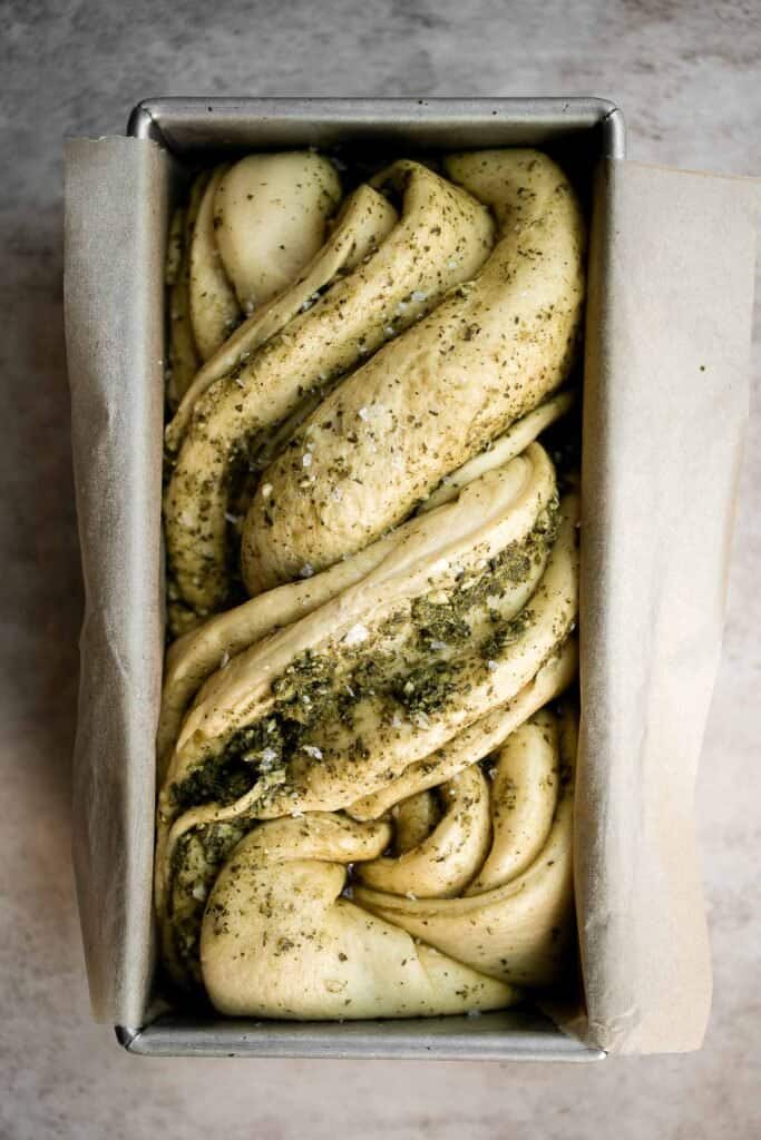 Pesto babka is a showstopping loaf of bread that is savory, delicious, and flavorful with beautiful twists and turns. Plus, it is surprisingly easy to make! | aheadofthyme.com