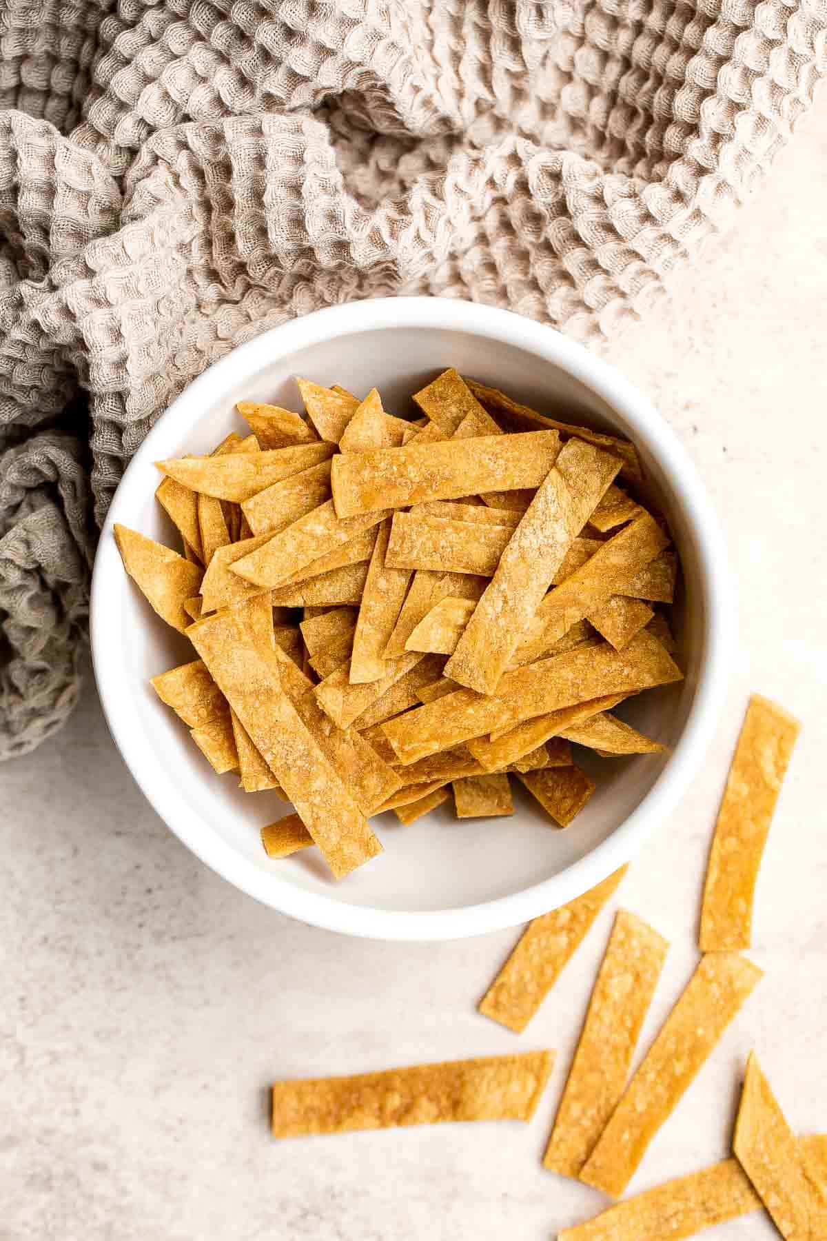 Homemade tortilla strips are crispy, crunchy, delicious, and easy to make using 3 simple ingredients. Serve as a snack or a topping on soups and salad. | aheadofthyme.com