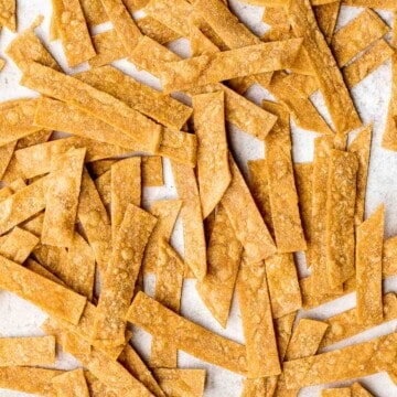 Homemade tortilla strips are crispy, crunchy, delicious, and easy to make using 3 simple ingredients. Serve as a snack or a topping on soups and salad. | aheadofthyme.com