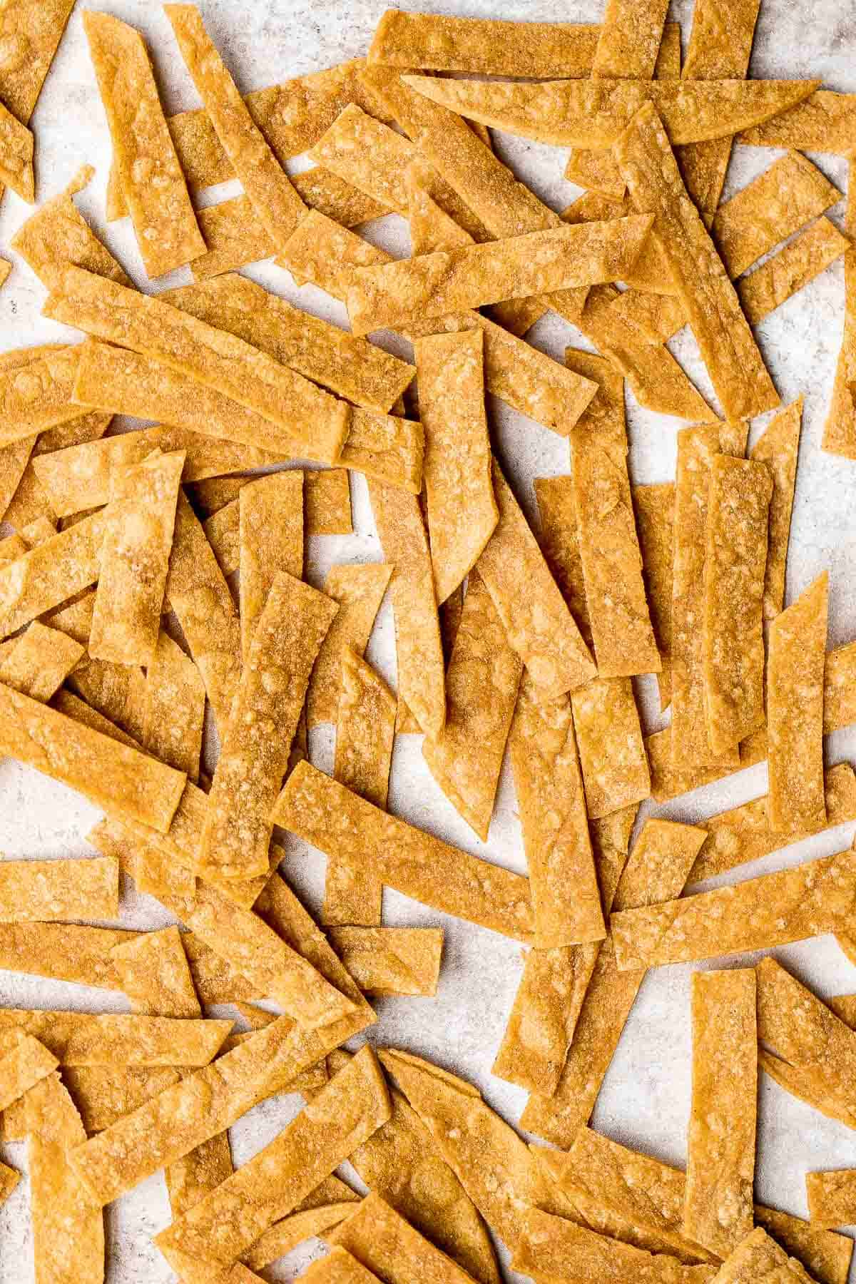 Homemade tortilla strips are crispy, crunchy, delicious, and easy to make using 3 simple ingredients. Serve as a snack or a topping on soups and salad. | aheadofthyme.com