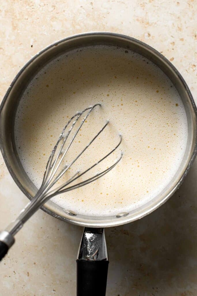 Vanilla pudding ingredients mixed together in a saucepan before heating. | aheadofthyme.com