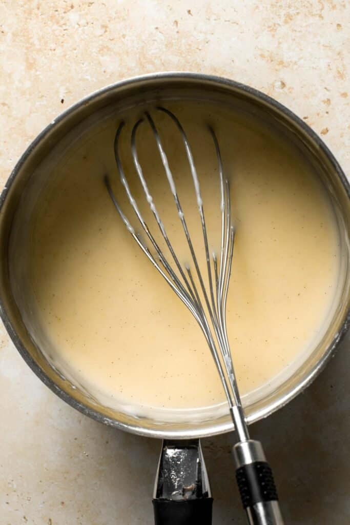 Cooked vanilla pudding in a saucepan. | aheadofthyme.com