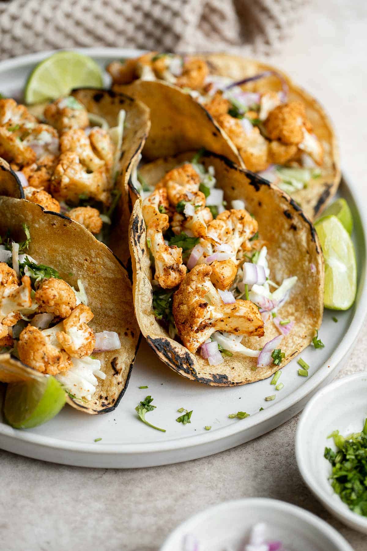 Vegetarian cauliflower tacos are loaded with air-fried or baked cauliflower, a delicious seasoning blend, and creamy lime cilantro slaw inside a tortilla. | aheadofthyme.com