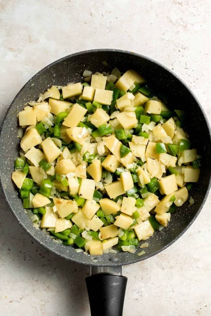 Sautéed vegetables in a skillet. | aheadofthyme.com