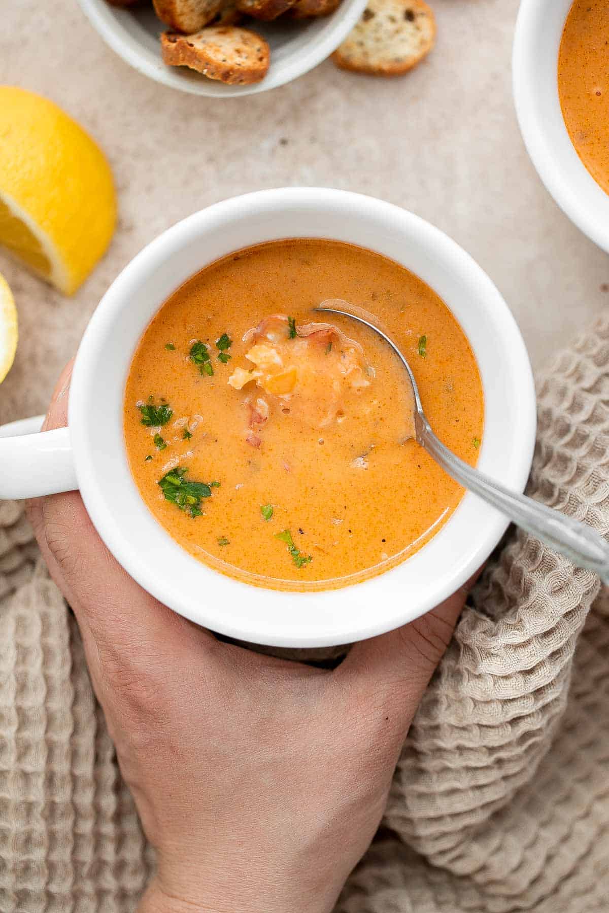 Homemade lobster bisque is rich and creamy, loaded with seafood flavor, and delicious. Serve this quick and easy soup with soft bread for lunch or dinner. | aheadofthyme.com