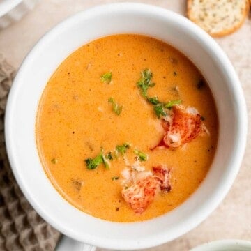 Homemade lobster bisque is rich and creamy, loaded with seafood flavor, and delicious. Serve this quick and easy soup with soft bread for lunch or dinner. | aheadofthyme.com