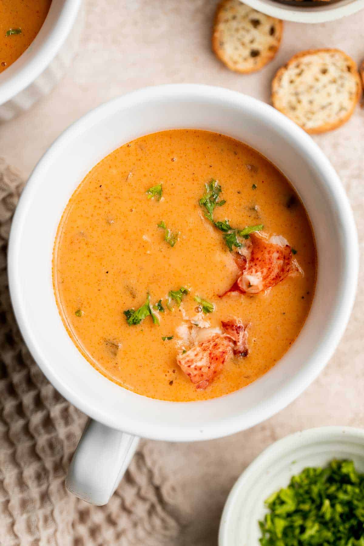 Homemade lobster bisque is rich and creamy, loaded with seafood flavor, and delicious. Serve this quick and easy soup with soft bread for lunch or dinner. | aheadofthyme.com