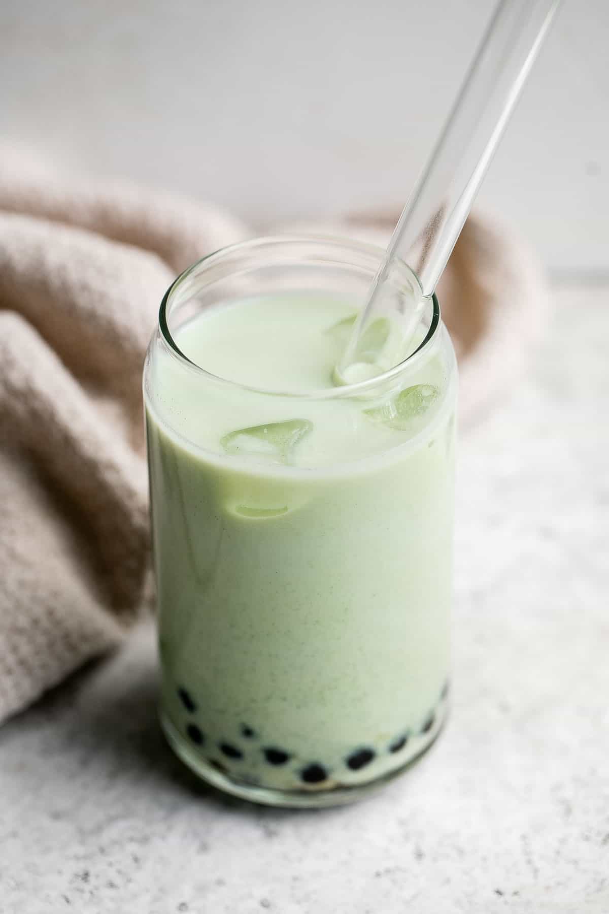 Iced Matcha Milk Tea with boba tapioca pearls is rich, refreshing, and delicious. Made with 3 ingredients, matcha bubble tea is easy to make at home. | aheadofthyme.com