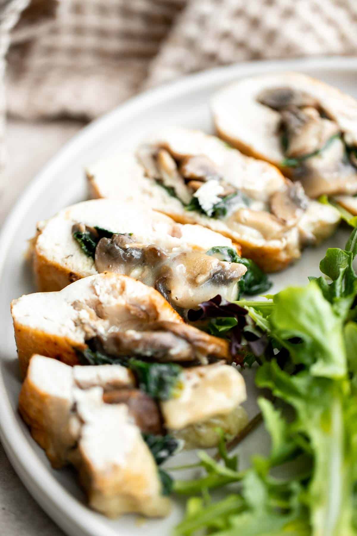 Stuffed Chicken Breasts loaded with mushrooms and spinach are juicy, tender, and flavorful. A handful of simple ingredients transforms regular chicken. | aheadofthyme.com