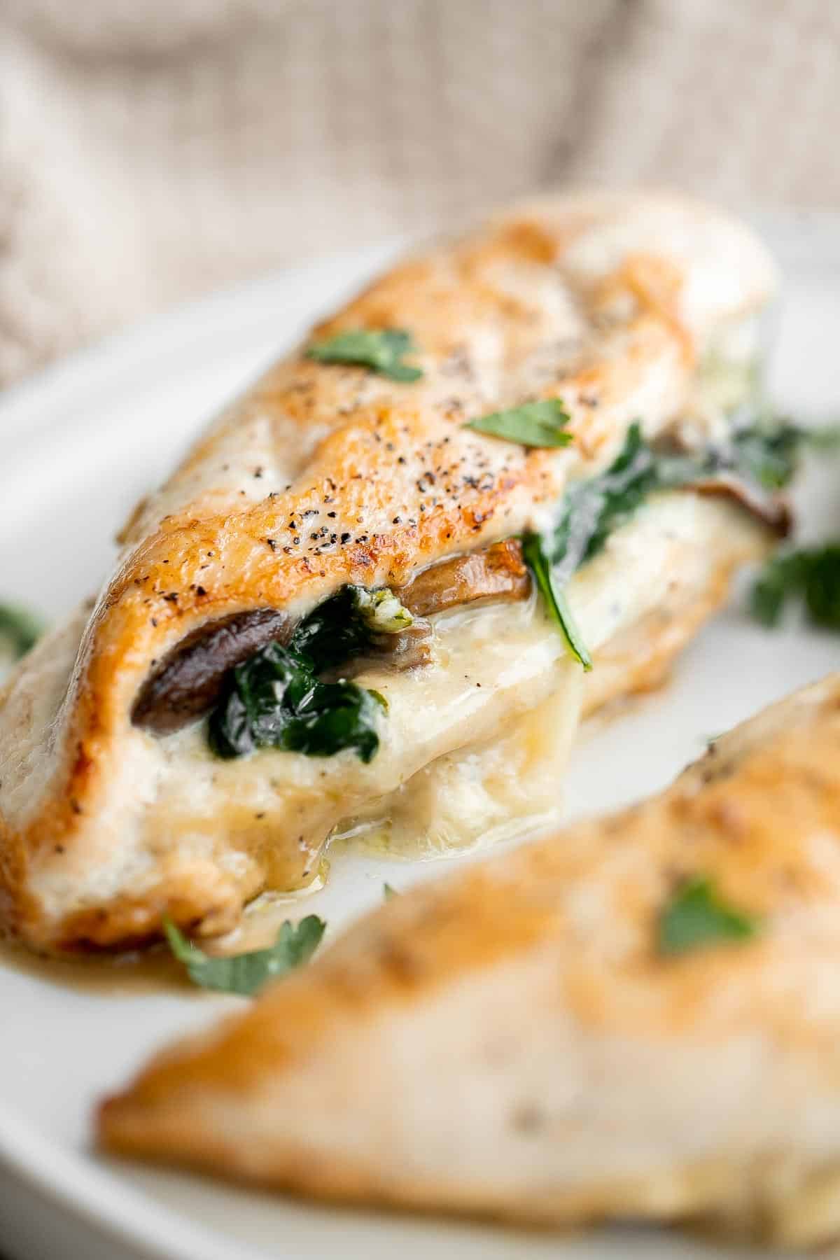 Stuffed Chicken Breasts loaded with mushrooms and spinach are juicy, tender, and flavorful. A handful of simple ingredients transforms regular chicken. | aheadofthyme.com