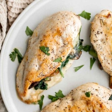 Stuffed Chicken Breasts loaded with mushrooms and spinach are juicy, tender, and flavorful. A handful of simple ingredients transforms regular chicken. | aheadofthyme.com