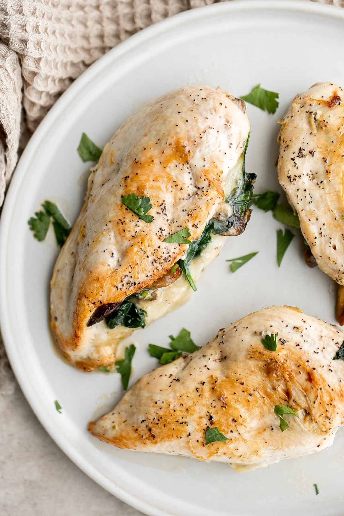 Stuffed Chicken Breasts loaded with mushrooms and spinach are juicy, tender, and flavorful. A handful of simple ingredients transforms regular chicken. | aheadofthyme.com