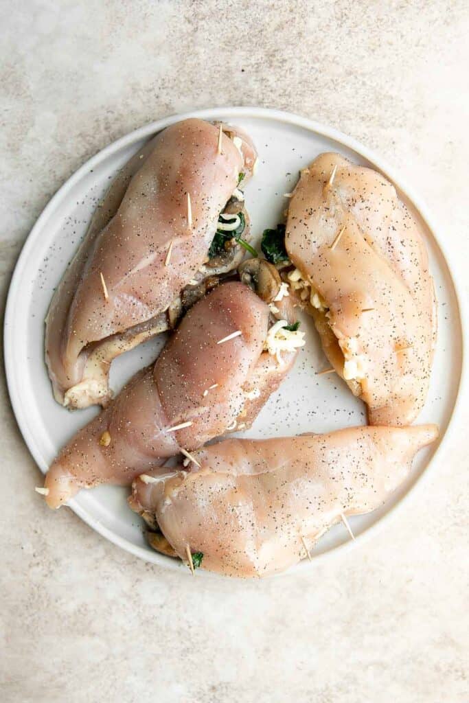 Stuffed Chicken Breasts loaded with mushrooms and spinach are juicy, tender, and flavorful. A handful of simple ingredients transforms regular chicken. | aheadofthyme.com