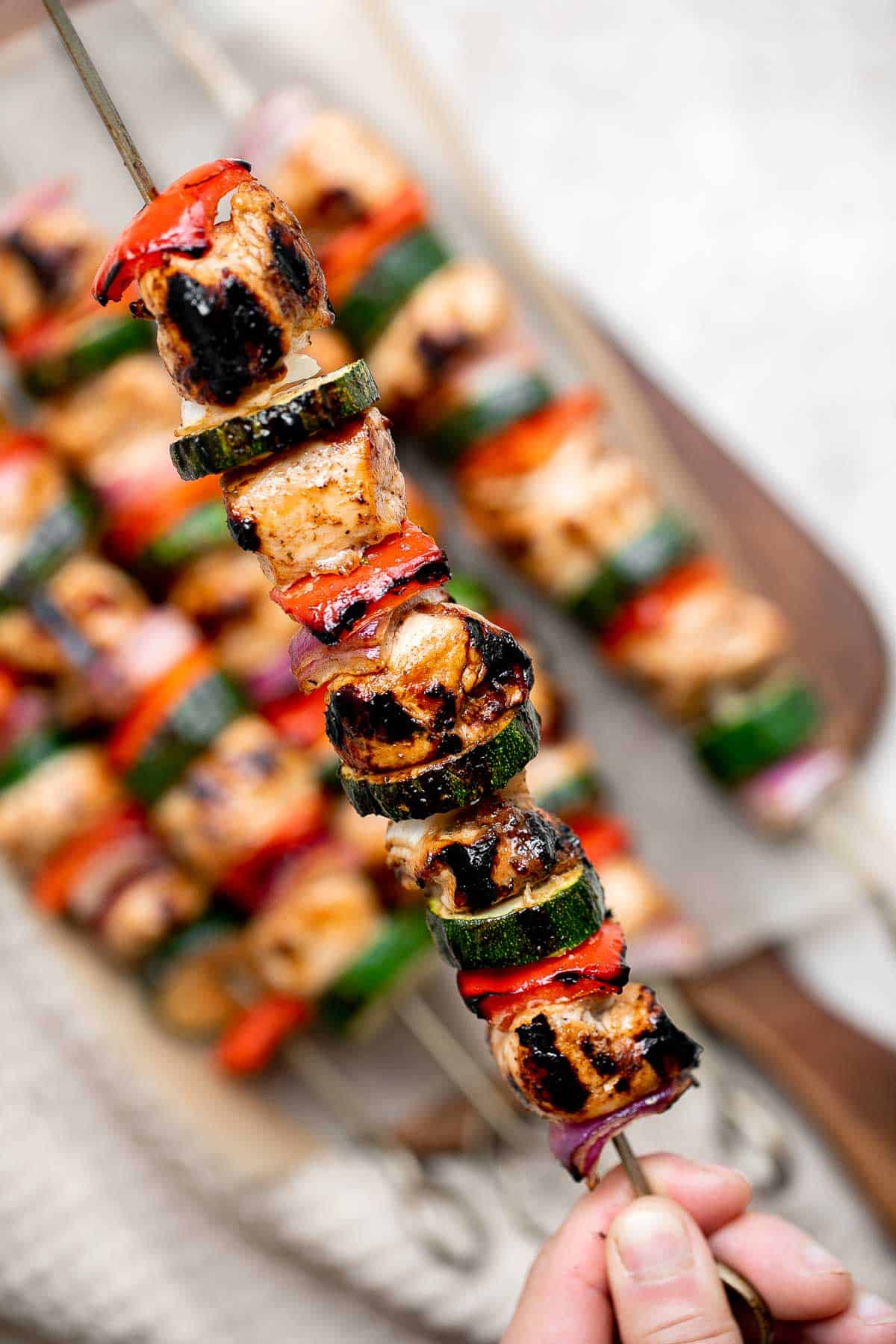 Grilled Balsamic Chicken Kabobs are a delicious flavorful summer grill staple marinated in a balsamic sauce, skewered with vegetables, and grilled or baked. | aheadofthyme.com