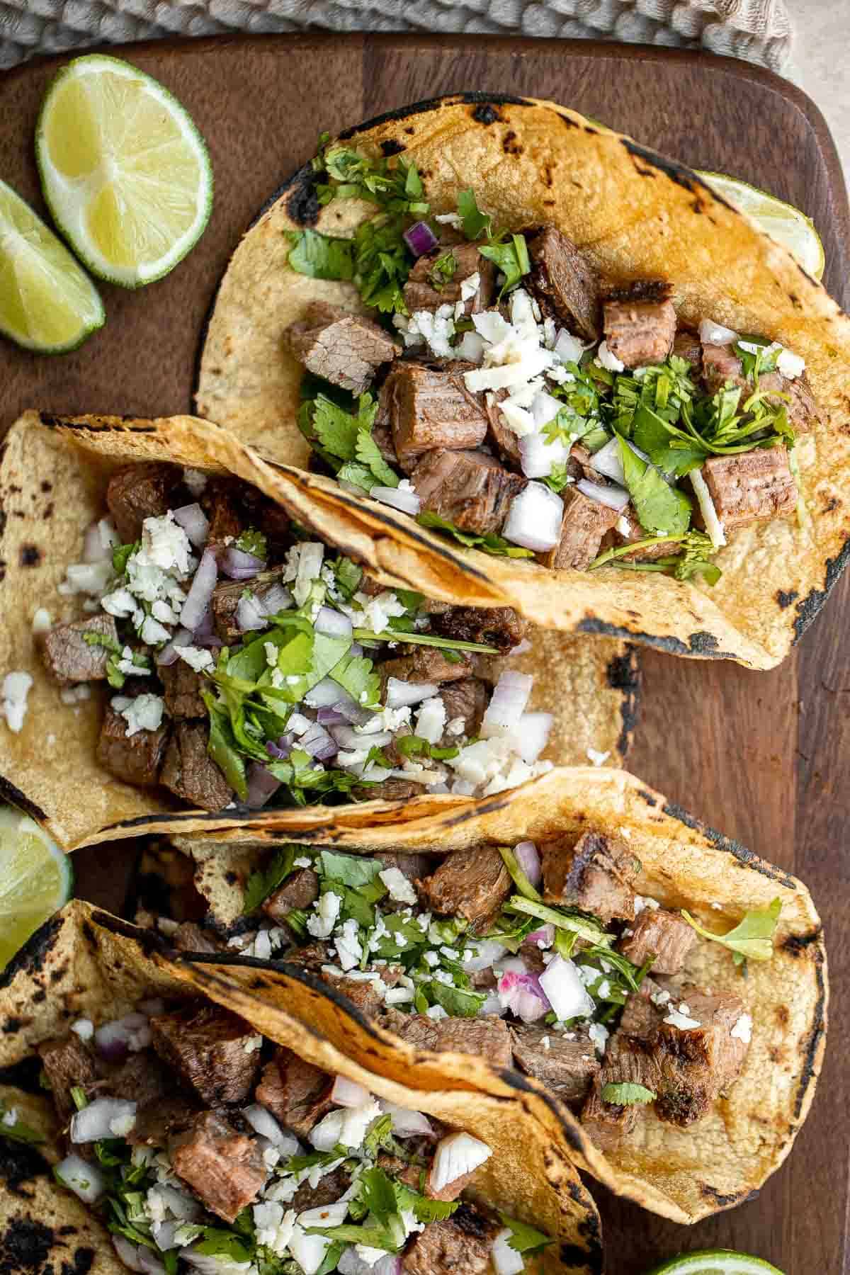 Carne asada tacos are delicious, juicy, and tender Mexican street tacos loaded with steak bites that everyone will be raving about on Taco Tuesday! | aheadofthyme.com
