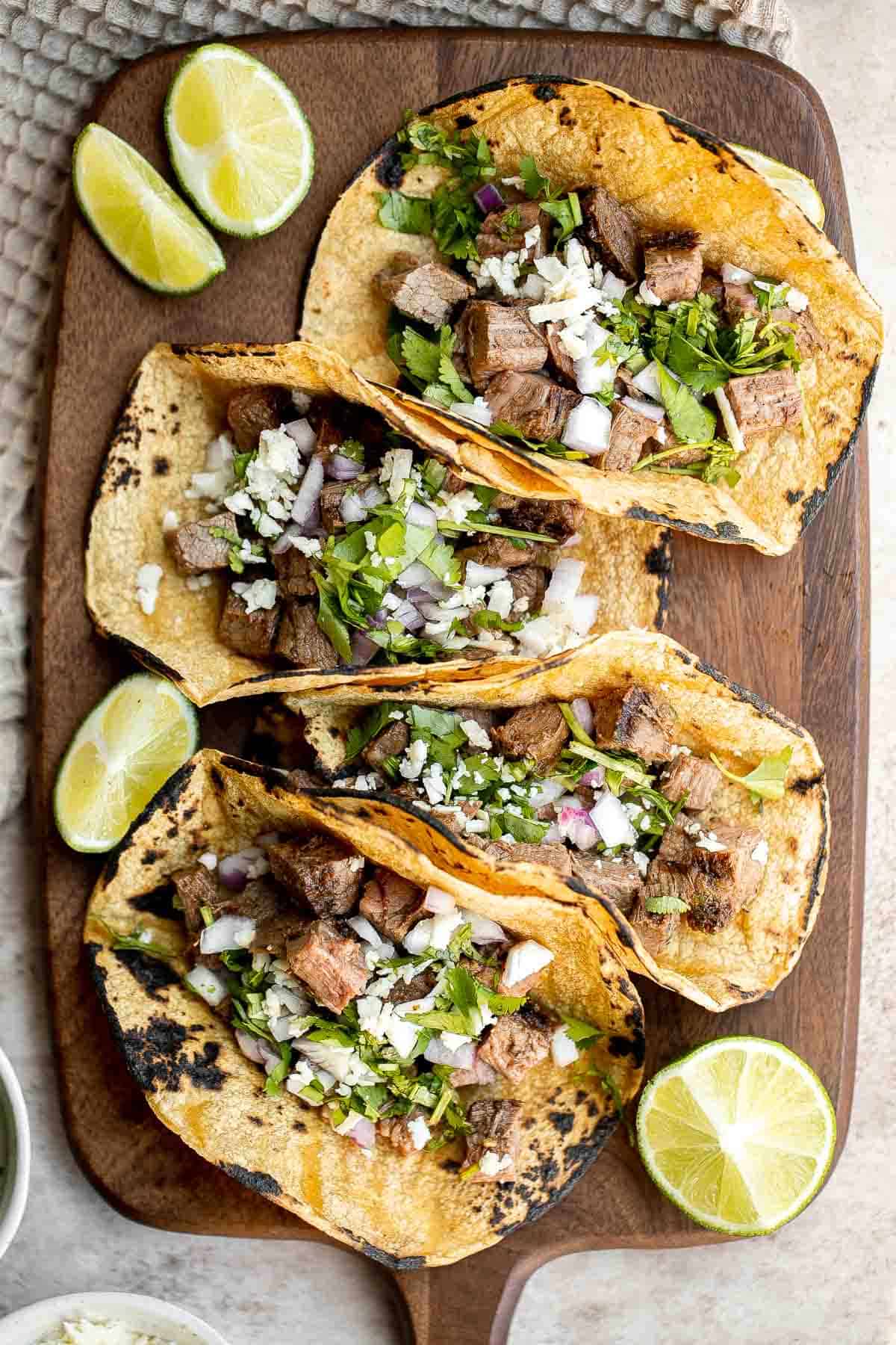 Carne asada tacos are delicious, juicy, and tender Mexican street tacos loaded with steak bites that everyone will be raving about on Taco Tuesday! | aheadofthyme.com