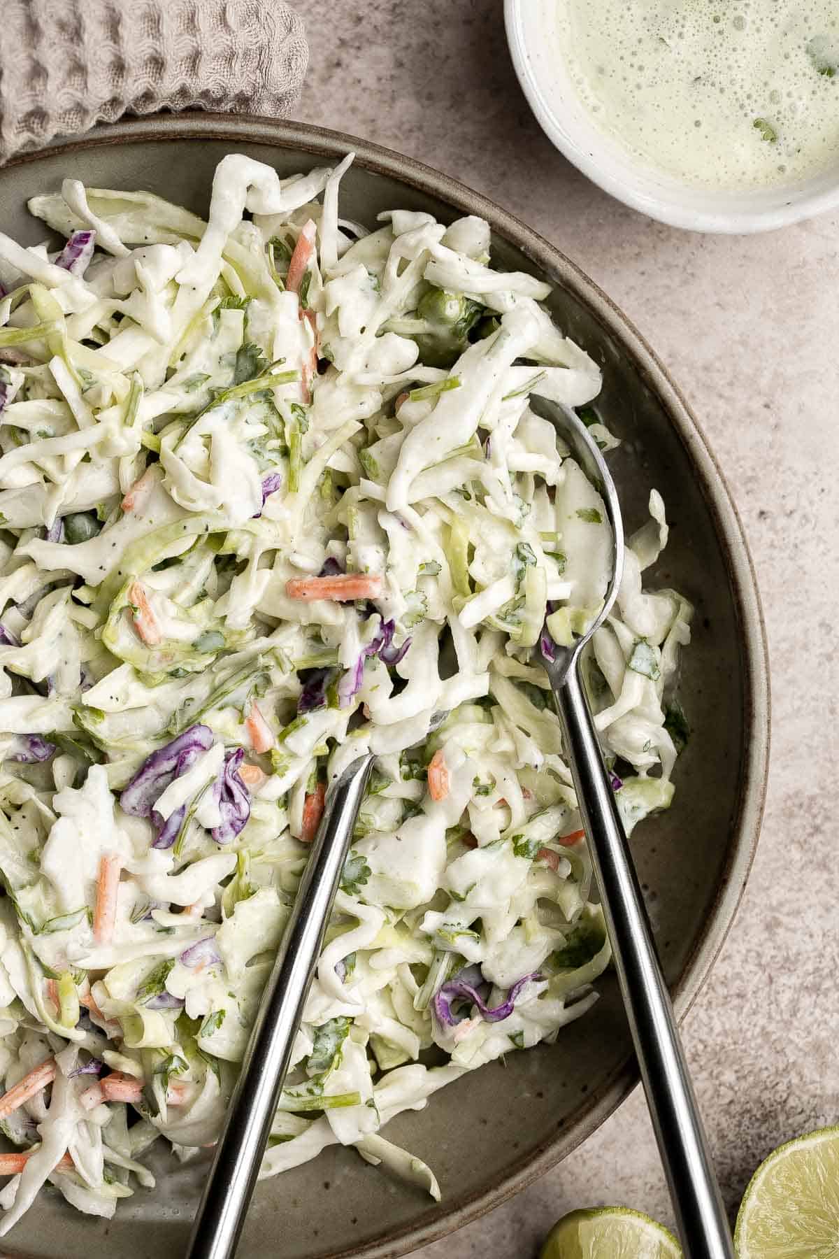 Cilantro lime slaw is fresh, light, crunchy, and zesty. Ready in 5 minutes, it’s the perfect pairing for tacos, burgers, sandwiches, and barbecued meats. | aheadofthyme.com