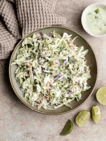 Cilantro lime slaw is fresh, light, crunchy, and zesty. Ready in 5 minutes, it’s the perfect pairing for tacos, burgers, sandwiches, and barbecued meats. | aheadofthyme.com