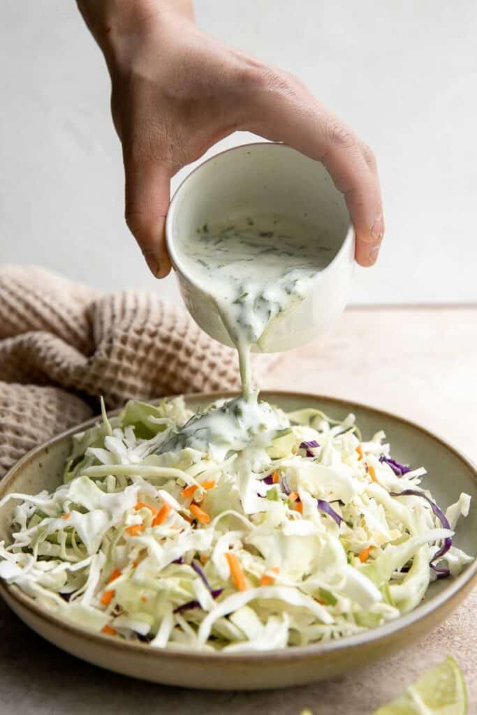 Cilantro lime slaw is fresh, light, crunchy, and zesty. Ready in 5 minutes, it’s the perfect pairing for tacos, burgers, sandwiches, and barbecued meats. | aheadofthyme.com